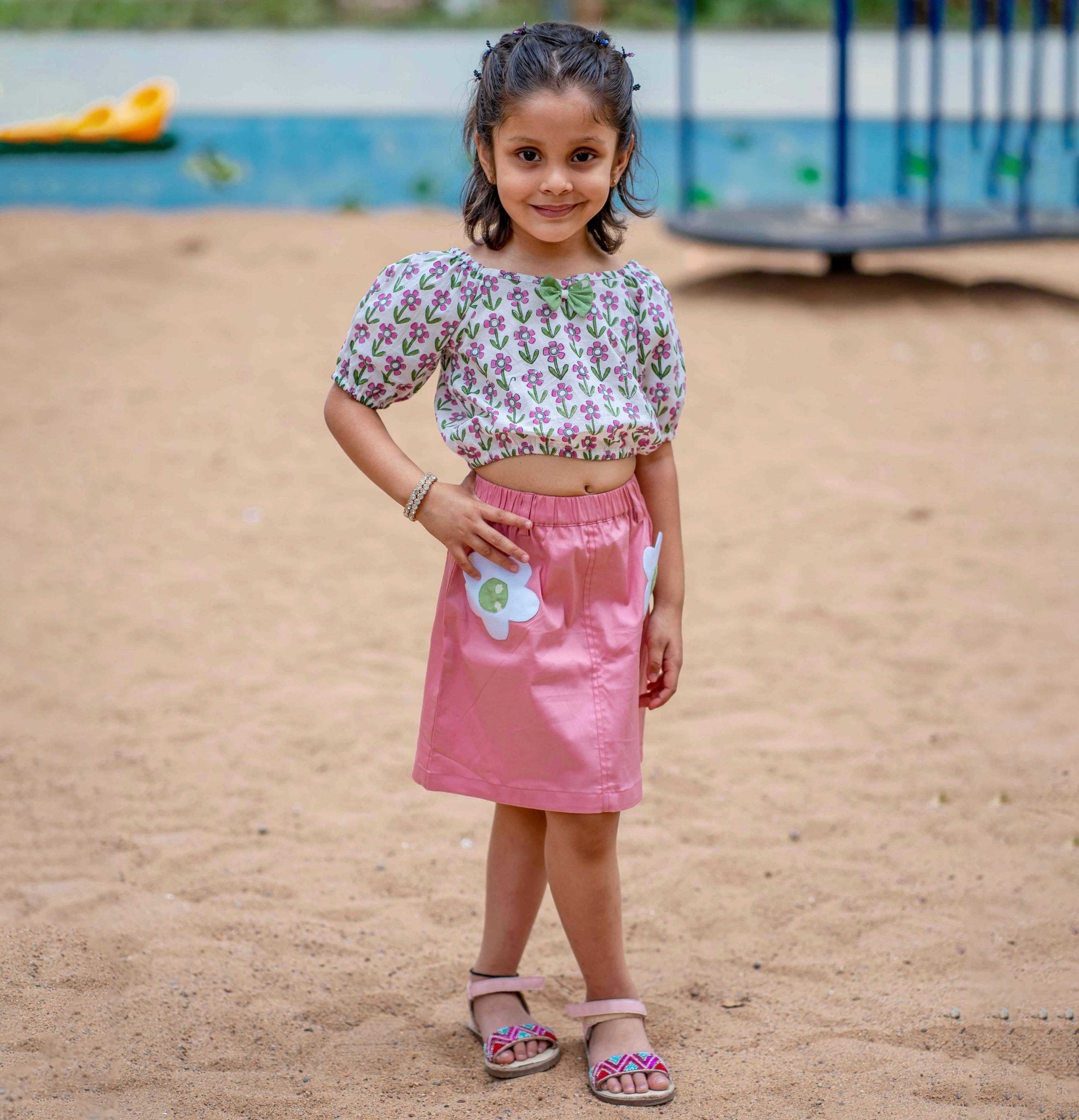 A girl wearing Block print cotton crop top and peach skirt with flowers