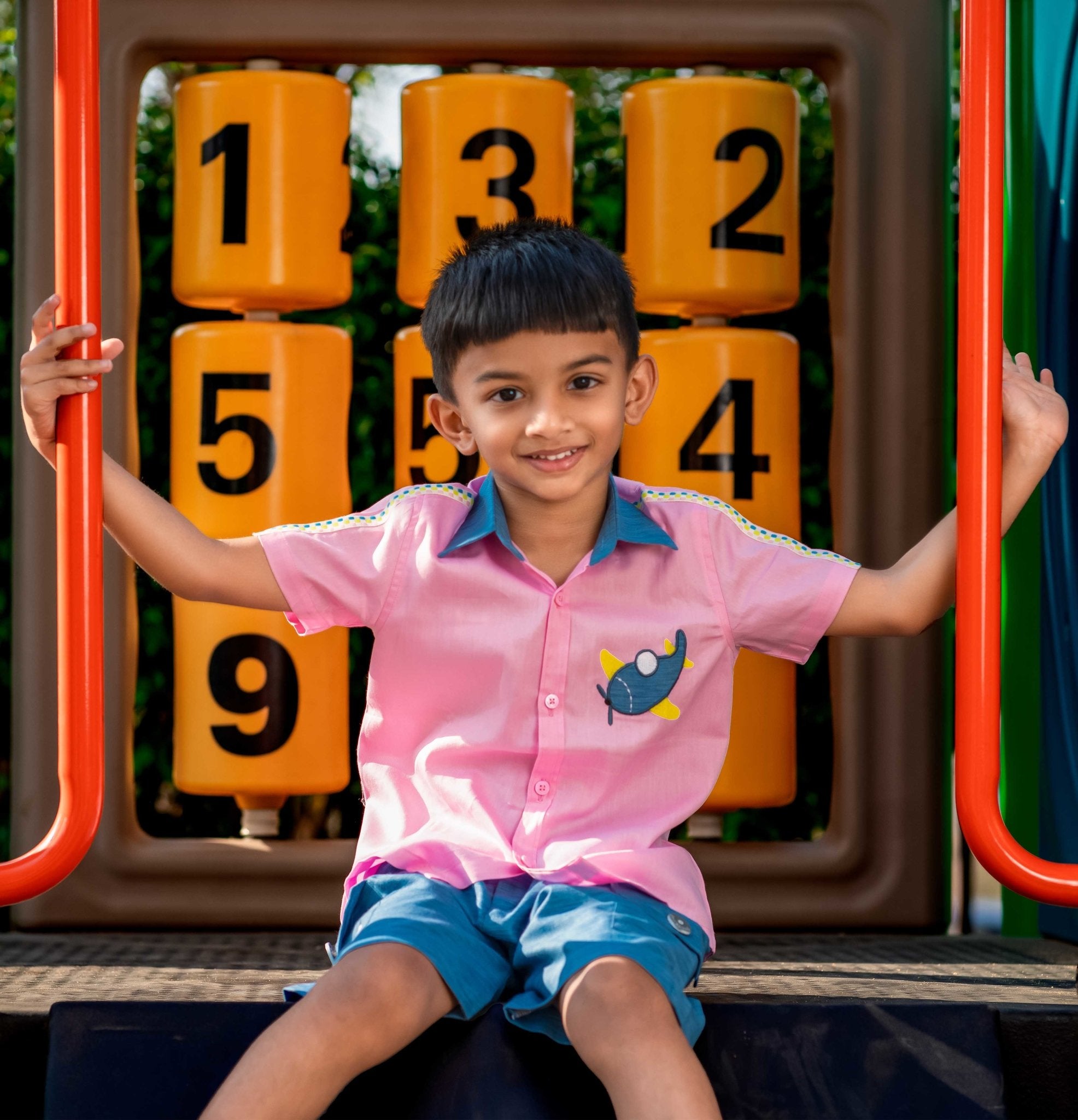 Boy wearing Candy pink Aeroplane shirt & light Denim Shorts 